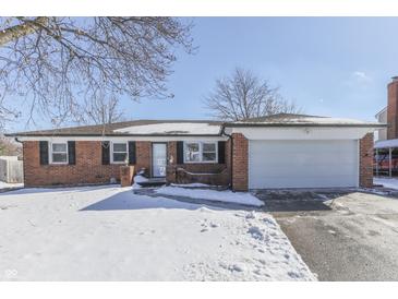 Brick ranch house with attached garage, snow-covered yard at 4543 Candy Spots Dr, Indianapolis, IN 46237