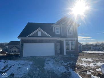 Charming two-story home with stone accents, attached garage, and a beautifully landscaped yard at 4751 E Shadowbrook Dr, Camby, IN 46113