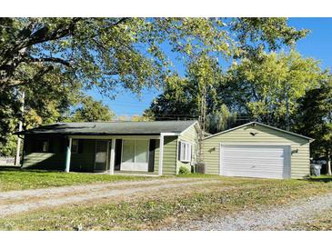 Ranch home with green exterior, covered porch, and detached garage at 644 Fankboner Ct, Greenwood, IN 46143