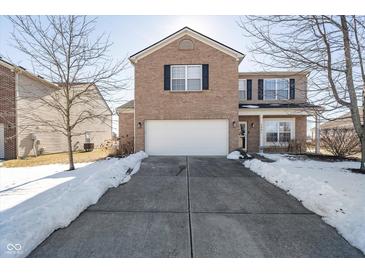 Two-story brick home with attached garage and snow-covered driveway at 7541 Mather Ln, Indianapolis, IN 46239