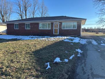 Brick ranch house with a landscaped lawn and driveway at 4905 W Southern Ave, Indianapolis, IN 46241