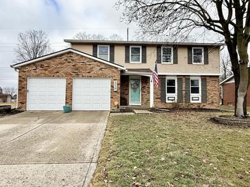 Brick two-story house with attached two-car garage and American flag at 600 Brentwood W Dr, Plainfield, IN 46168