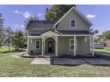 Charming gray house with a metal roof and front porch at 7077 E Mulberry St, Gwynneville, IN 46144