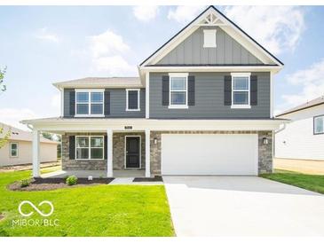 Charming two-story home with gray siding, black shutters, covered porch, and a two-car garage at 7541 Big Bend Blvd, Camby, IN 46113