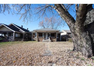 Brick house with front porch, steps, and tree in the yard at 836 S Tremont St, Indianapolis, IN 46221