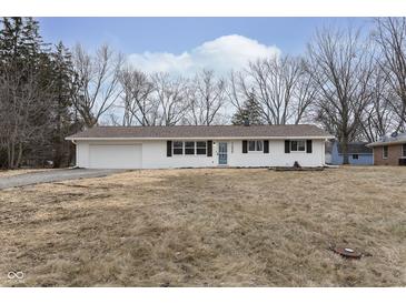 Newly renovated ranch home with white brick exterior, brown roof and a spacious yard at 1238 Orchard N Park, Carmel, IN 46280