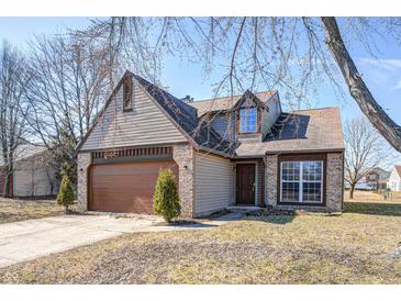Charming two-story home with a brick and vinyl exterior, attached garage, and manicured front yard at 368 Seabreeze Cir, Avon, IN 46123