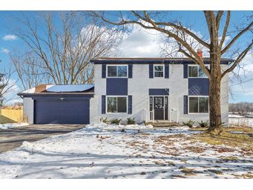 Two-story house with white brick, navy blue accents, and a spacious yard at 4155 Senour Rd, Indianapolis, IN 46239