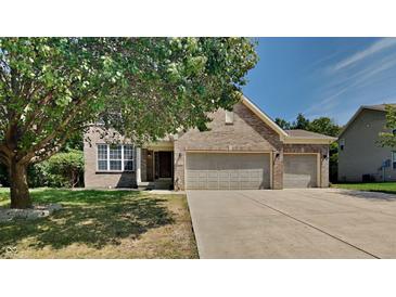 Brick house with 3-car garage and landscaped lawn at 5131 Nicodemus Dr, Plainfield, IN 46168