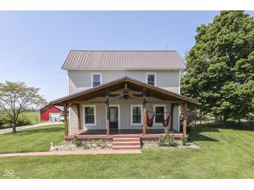 Charming two-story home with a covered front porch and mature trees offering a relaxing outdoor space at 5750 W 300 N Rd, Bargersville, IN 46106