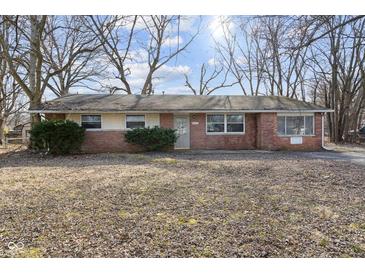 Brick ranch house with a large front yard at 6847 W 15Th St, Indianapolis, IN 46214
