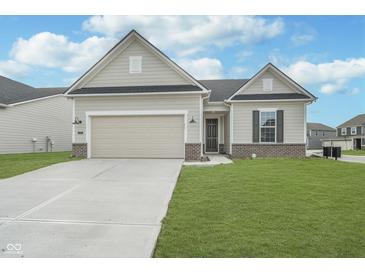 Charming single-story home with a two-car garage, well-maintained lawn, and neutral exterior paint at 7300 Legends Way, Whitestown, IN 46052