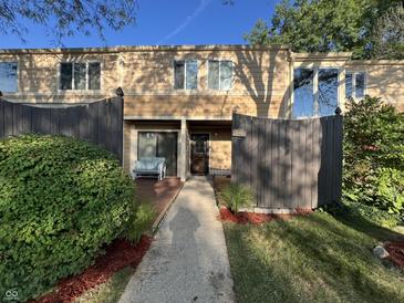 Tan-colored townhouse exterior with a wooden fence and walkway at 741 Ironwood Dr, Avon, IN 46123