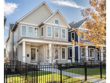 Two-story house with gray siding, black fence, and landscaped lawn at 1561 N Park Ave, Indianapolis, IN 46202