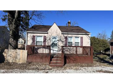 Quaint house with brown deck and purple shutters at 302 E Cowing Dr, Muncie, IN 47303