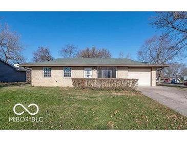 Ranch style home with attached garage and well-manicured lawn at 10138 Catalina Dr, Indianapolis, IN 46235