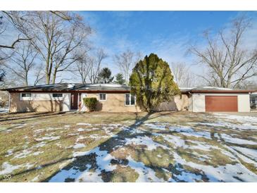 Ranch home with attached garage, situated on a spacious lot with mature trees at 4820 E 70Th St, Indianapolis, IN 46220
