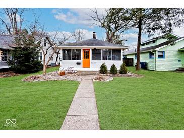Charming single-story home with an orange front door and a well-maintained front yard at 5630 Winthrop Ave, Indianapolis, IN 46220
