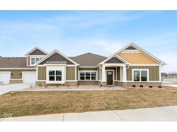 Modern craftsman style home with gray and yellow exterior, and a well-manicured lawn at 6207 Preserve Way, McCordsville, IN 46055