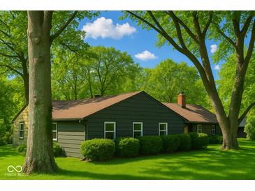 Charming single-story home with dark siding, complemented by lush green lawns and mature trees at 6220 Dean Rd, Indianapolis, IN 46220