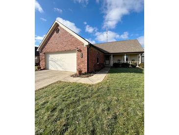 Brick ranch home with attached garage and landscaped yard at 134 President W Trl, Indianapolis, IN 46229