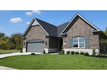 Brick house with gray garage door and landscaped lawn at 2212 Galleone Way, Plainfield, IN 46168