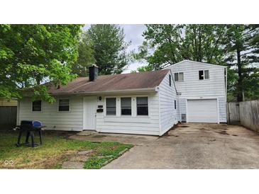 White house with attached garage and small yard at 4013 Patricia St, Indianapolis, IN 46222