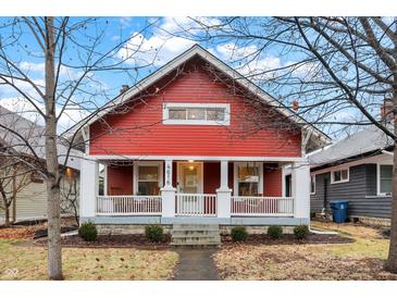 Charming red home with white trim, inviting porch, and well-maintained landscaping at 4616 Carrollton Ave, Indianapolis, IN 46205
