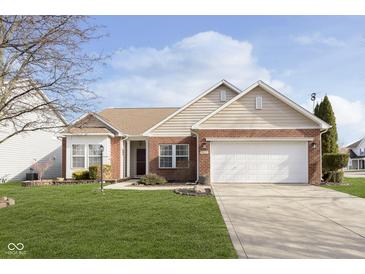 Brick ranch home with a two-car garage and well-maintained lawn at 5437 Basin Park Dr, Indianapolis, IN 46239