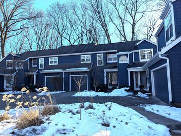 Front view of a charming blue two-story home with attached garage at 7841 Harbour # 35, Indianapolis, IN 46240