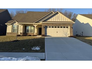 Brick ranch home with a two-car garage and landscaped lawn at 2746 Lanai Ln, Greenwood, IN 46143
