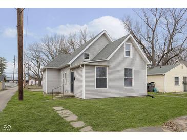 Charming home featuring gray siding, a well-maintained lawn, and a classic architectural design at 3102 N Arsenal Ave, Indianapolis, IN 46218
