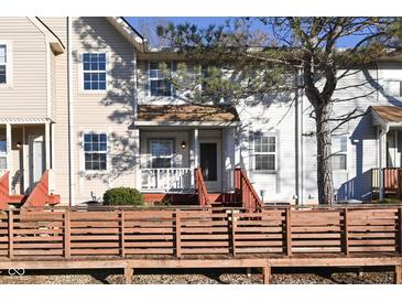 Tan two-story townhome with a wooden deck and small front yard at 6639 N College Ave, Indianapolis, IN 46220