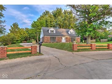 Charming brick home featuring a well-manicured front yard and a long driveway with curb appeal at 1753 Skyline Dr, Greenwood, IN 46143