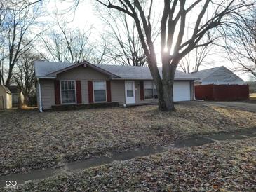 Ranch style home with attached garage and mature tree in front yard at 1908 Edgemont Way, Anderson, IN 46011