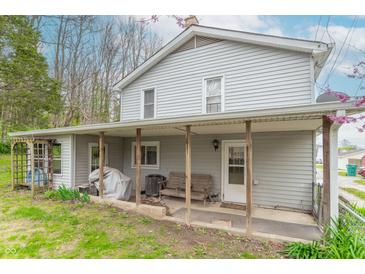 Charming two-story home featuring a covered porch with seating, perfect for enjoying the outdoors at 310 Green St, Plainfield, IN 46168