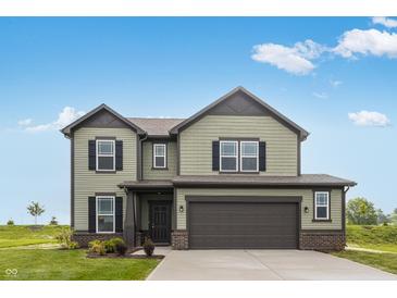 Two-story home with an attached garage, green siding, black shutters and a well-manicured lawn at 349 N Post Oak Dr, Mooresville, IN 46158