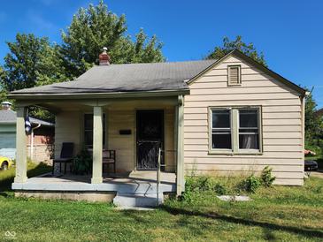 Tan colored house with front porch and yard at 3611 N Sherman Dr, Indianapolis, IN 46218