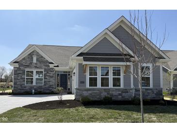Beautiful single-story home featuring stone accents, gray siding, and a well-manicured lawn, perfect for modern living at 15171 Covebrook Ln, Fishers, IN 46037
