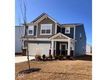 Charming two-story home with a covered porch, attached garage, and well-maintained lawn at 2322 Dixon Creek Dr, Whitestown, IN 46075