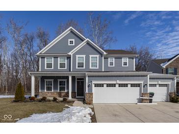 Two-story gray house with white trim, three-car garage, and landscaping at 453 Gathering Ln, Greenwood, IN 46143