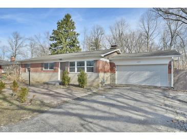 Brick ranch home with attached garage and landscaped yard at 4575 Ayrshire St, Indianapolis, IN 46228