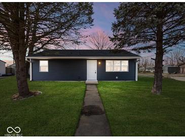 Newly built home with a dark blue exterior, well-manicured lawn, and walkway at 403 Wellington Blvd, Shelbyville, IN 46176