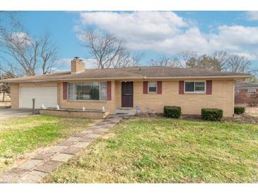 Ranch home with brick exterior, attached garage, and landscaped lawn at 6149 Winnpeny Ln, Indianapolis, IN 46220