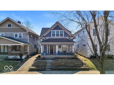 Charming two-story home with a covered front porch and inviting curb appeal at 625 Sanders St, Indianapolis, IN 46203