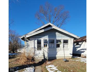 Light blue bungalow with white brick accents and small front yard at 710 N Drexel Ave, Indianapolis, IN 46201