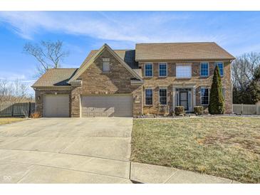 Beautiful two-story brick home with a well-manicured lawn and an attached two-car garage at 1295 Longleaf St, Avon, IN 46123
