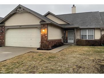 Charming home featuring an attached garage, brick accents and well maintained landscaping at 1348 Mccormicks Cir, Danville, IN 46122