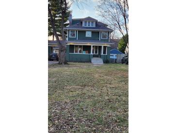 Green two-story house with a spacious lawn and attached garage at 5844 Central Ave, Indianapolis, IN 46220