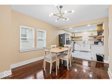 Bright dining area adjacent to the kitchen, featuring hardwood floors and natural light at 916 N Bradley Ave, Indianapolis, IN 46201